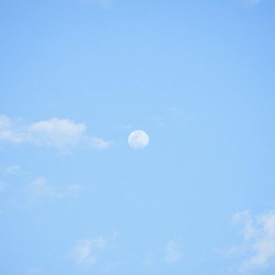 Clear blue sky with soft clouds